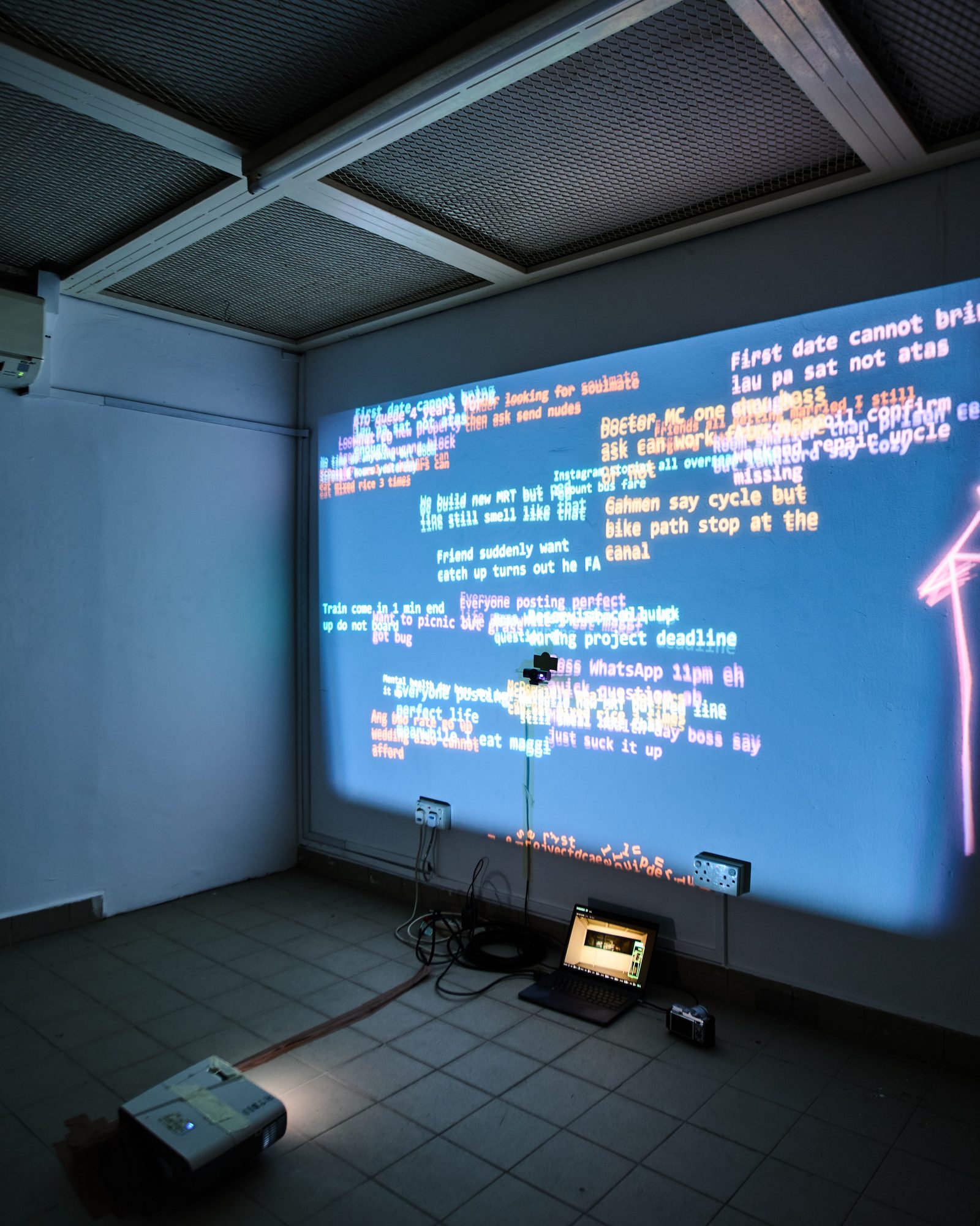 the supermoon room: the projection across the wall, a webcam on a stand, a laptop on the floor